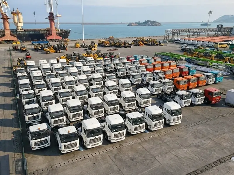 A group of kales trucks parked at the port, waiting for export.