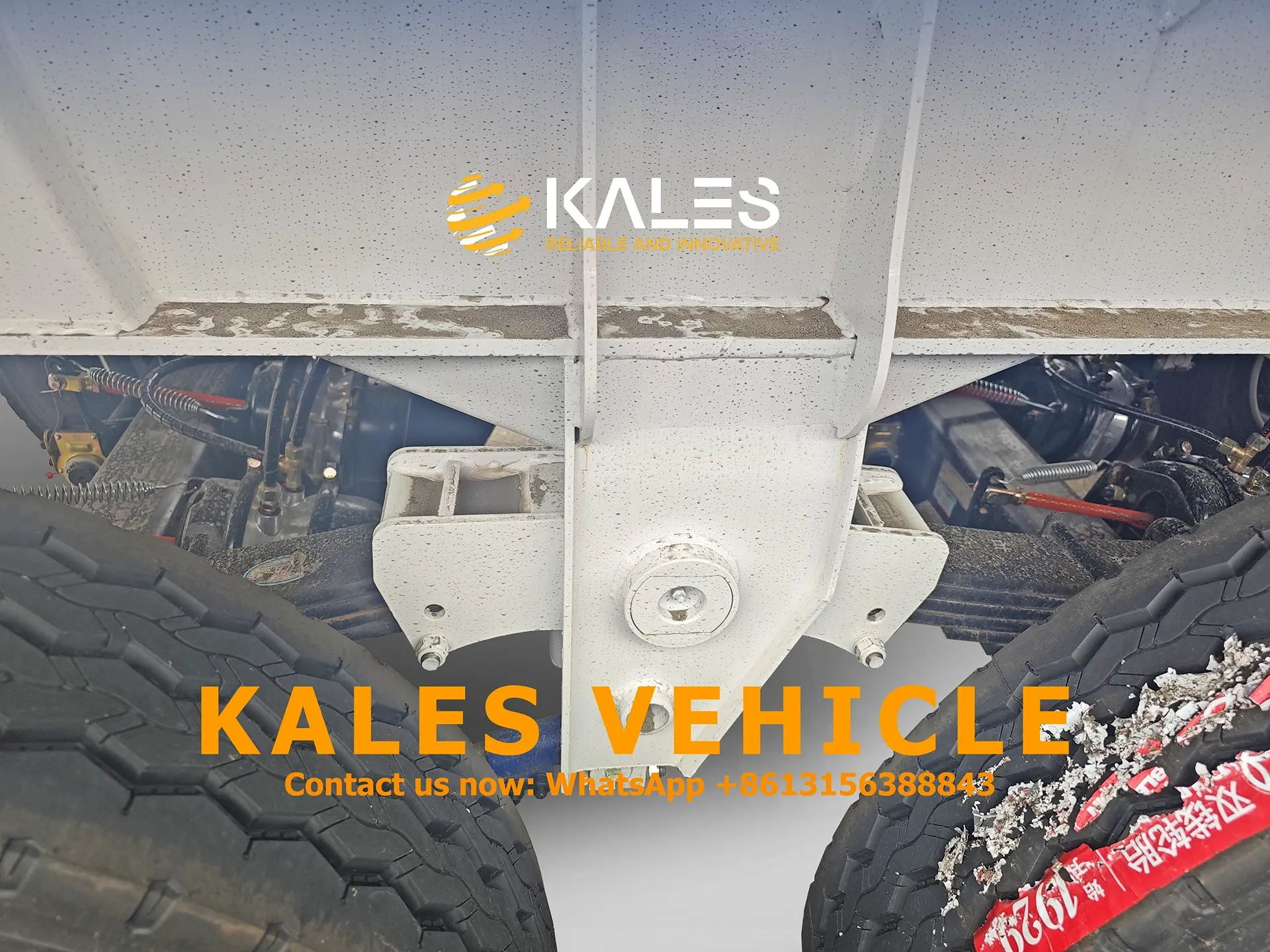 Heavy-duty axles, leaf springs, and reinforced suspension hangers on Kales Vehicle 60 ton dump trailer.