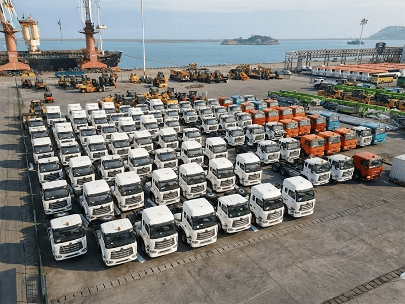 A group of kales trucks parked at the port, waiting for export.