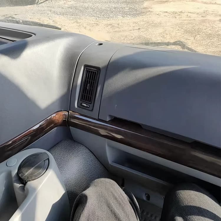 Refurbished cabin interior with new upholstery and dashboard on Kales Vehicle HOWO truck.