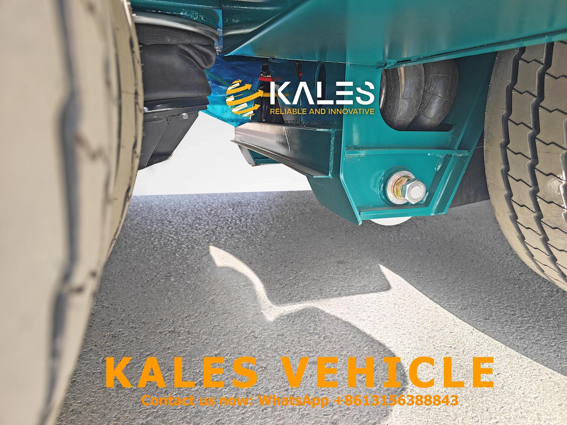 Air suspension system detail on car carrier trailer for shock absorption and cargo protection.
