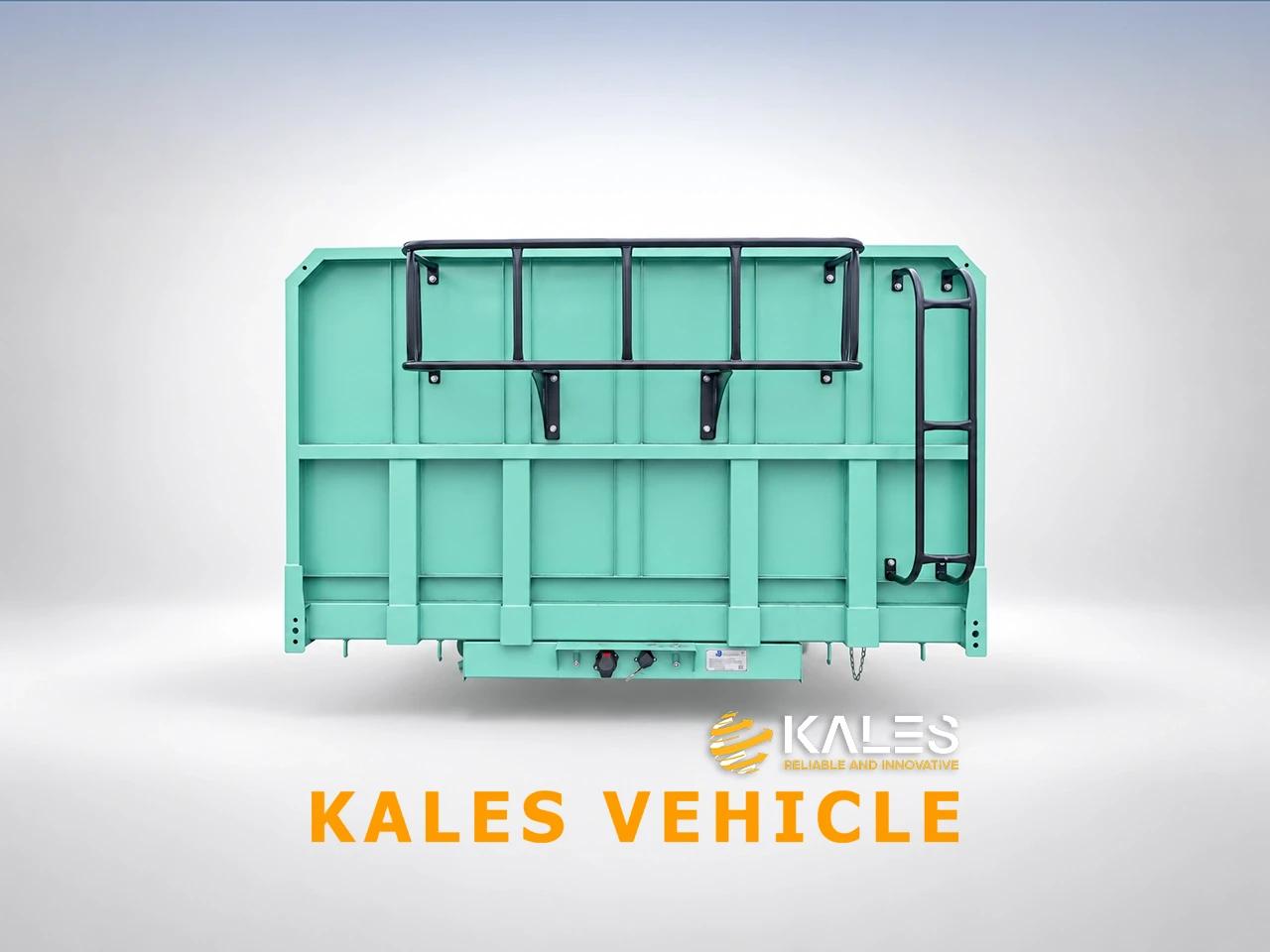 Front view of Kales side dump trailer featuring reinforced corrugated steel bulkhead and glad hands