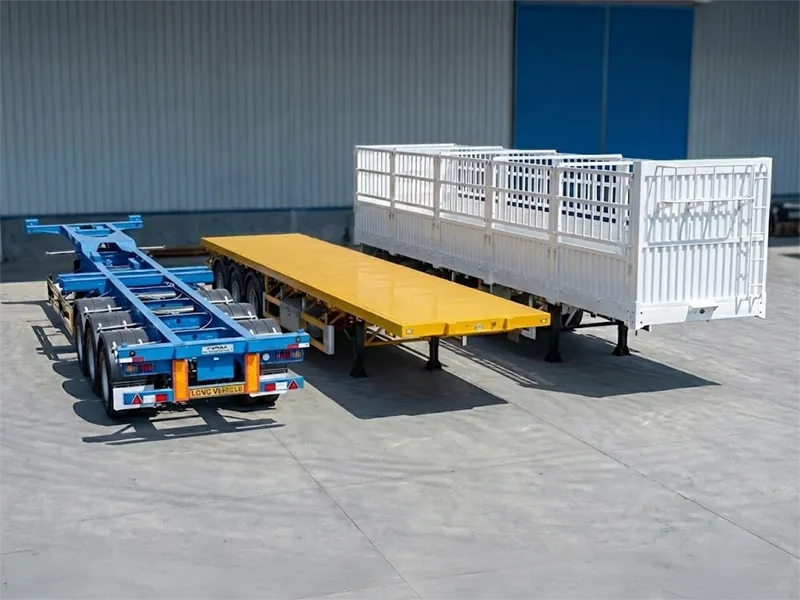 Lineup of Kales Vehicle transport solutions: Blue skeletal container chassis, Yellow flatbed trailer with front headboard, and White fence cargo trailer on factory floor.