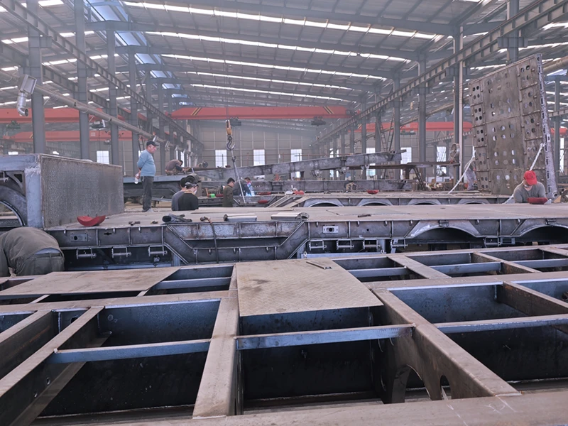 Skilled technician welding the main beam of a lowbed semi-trailer at Kales Vehicle factory.