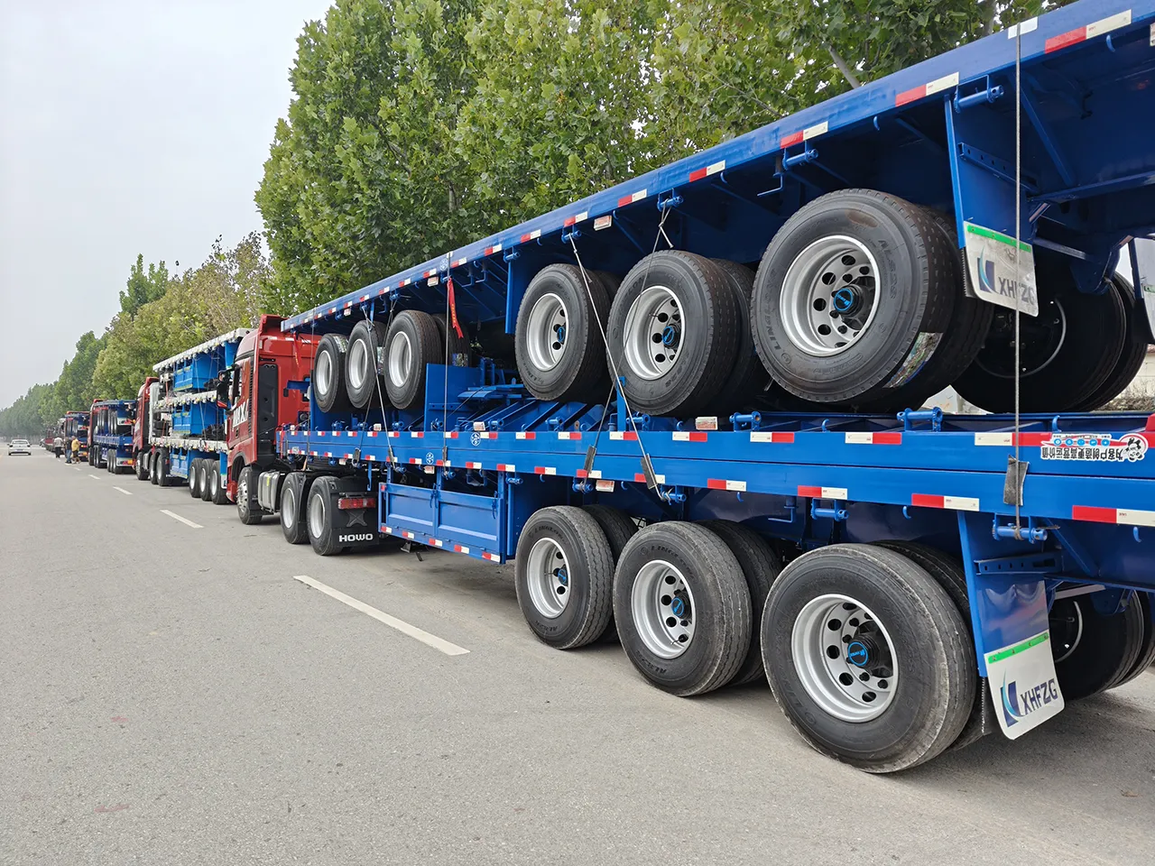 15 Kales 3-axle 40ft flatbed trailers loaded for Tianjin Port shipment to West Africa