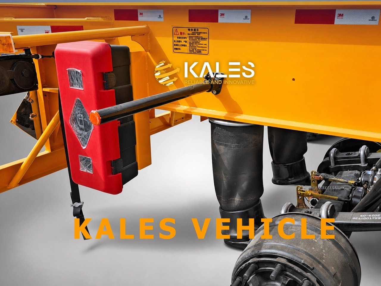 Protected red safety equipment cabinet mounted beside trailer air suspension