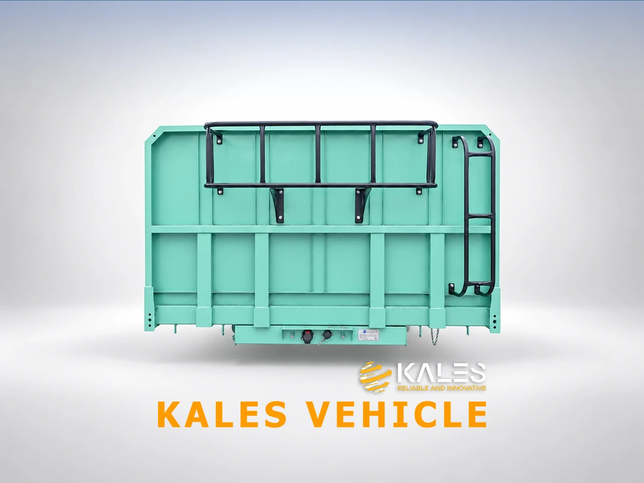 Front view of Kales side dump trailer featuring reinforced corrugated steel bulkhead and glad hands